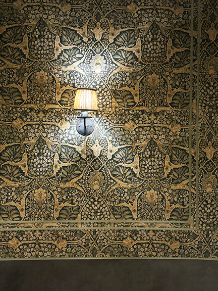 Lewis & Wood Alhambra patterned wallpaper at A.O.C. Brentwood designed by Nickey Kehoe, showcasing intricate foliage detail and rich texture.