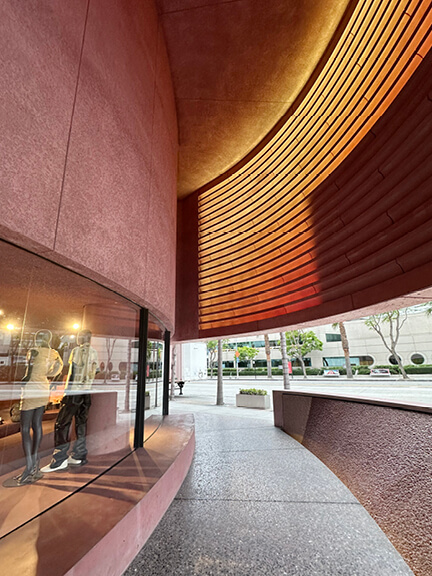 Pastel pink building exterior in West Hollywood—an eye-catching storefront on your Los Angeles Shopping and Dining route.