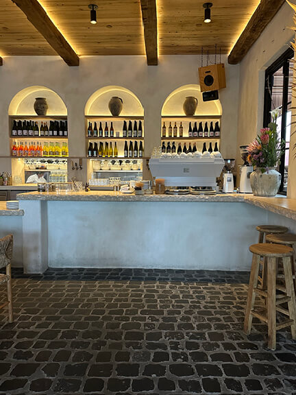 Plaster walls, arched openings, and tumbled stone flooring at The Great White in West Hollywood. A highlight of Los Angeles Shopping and Dining.