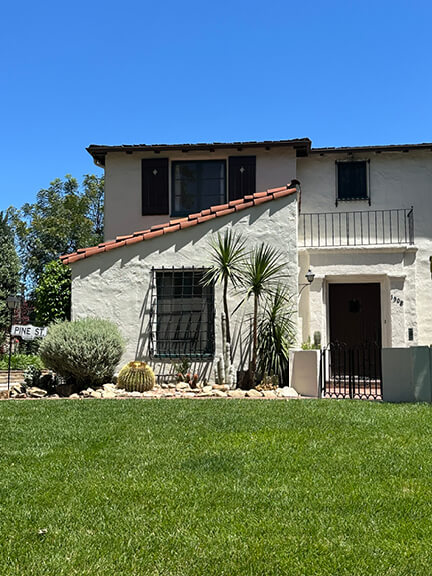 Spanish Colonial Revival home with red tile roof and arched windows—classic Los Feliz example of historic home design in Southern California.