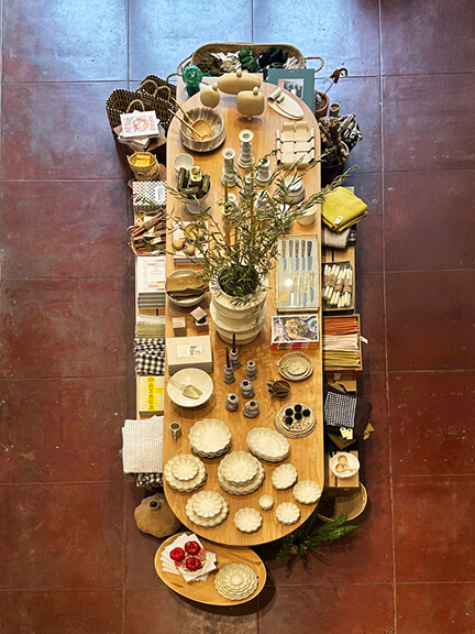 Curated tabletop decor at a Los Angeles home store, featuring ceramics, candles, and sculptural objects styled on natural wood and plaster surfaces
