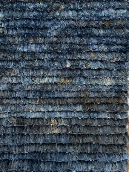 Blue fringed wool area rug at Ben Soleimani LA showroom with subtle striped pattern and vintage-inspired tones