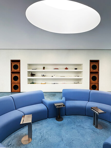 Modern interior at the Madhappy boutique in West Hollywood with blue concrete flooring and minimalist design elements.