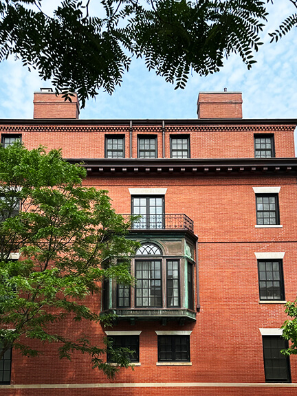 Victorian brick townhouse in Boston’s Back Bay with bay windows, dormers, and stone trim—an example of historic home design in Boston.
