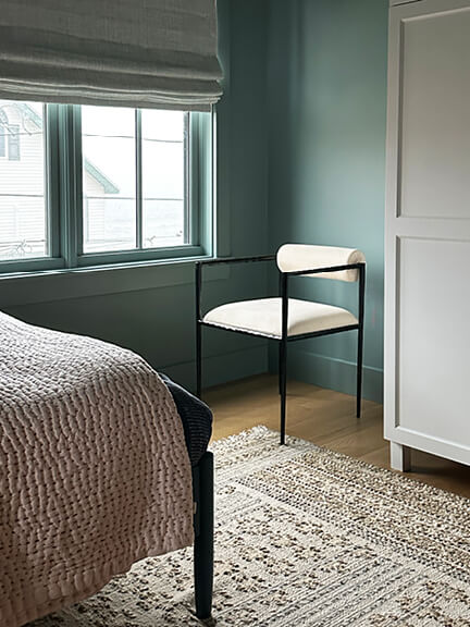 Dark blue-green bedroom with ocean views in a new construction beach house.