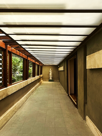 Hallway leading to courtyard at Hollyhock House in Los Angeles, part of postmodern architecture Los Angeles tour