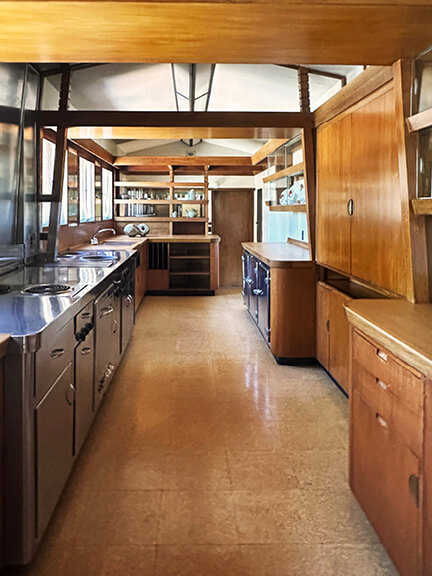 Stainless steel and wood cabinets in galley kitchen at Frank Lloyd Wright’s Hollyhock House, Los Angeles