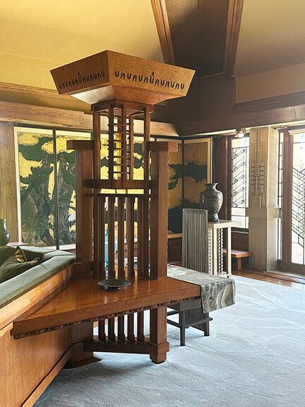 Living room with custom furniture at Frank Lloyd Wright’s Hollyhock House, part of postmodern architecture Los Angeles tour