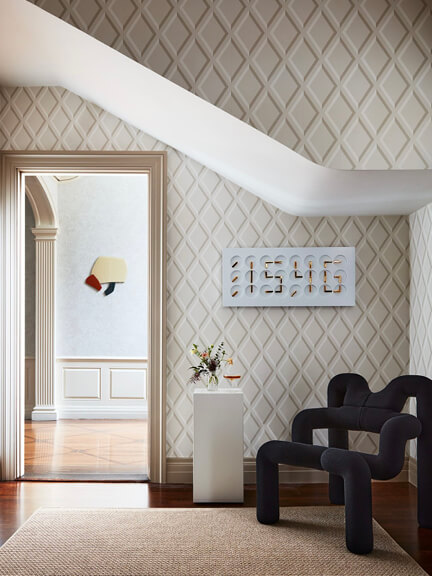 Art in interior design shown in a classic Concord home with historic architecture, modern furniture, and bold contemporary artwork