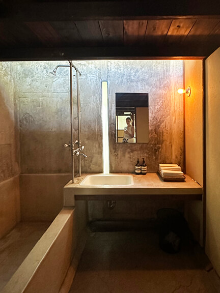 Concrete bathroom with integrated bathtub and sink, part of postmodern architecture Los Angeles tour