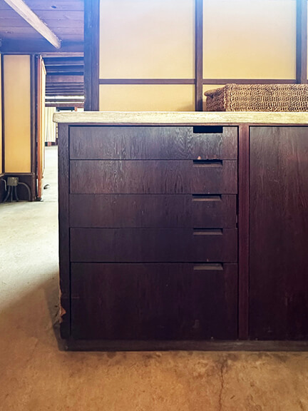 Custom dark wood kitchen cabinets with integrated pulls and asymmetrical design