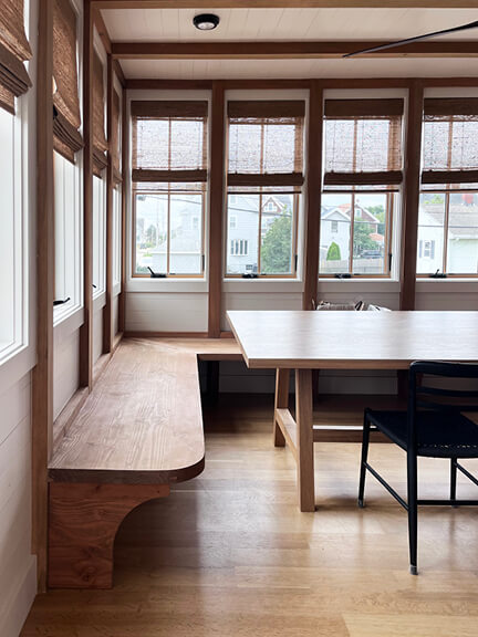 Sunroom with natural wood beams in a new construction beach house.