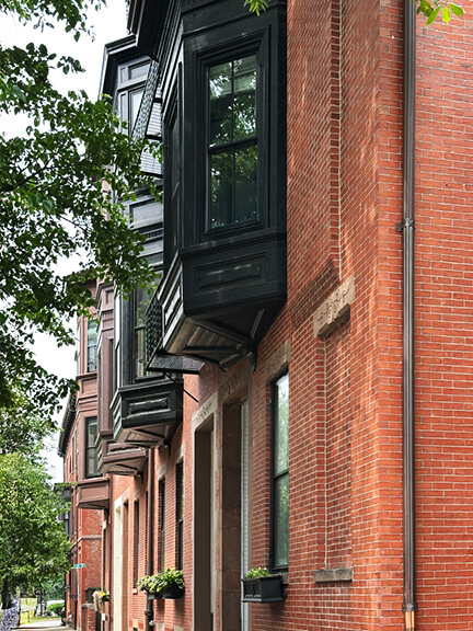 Upper-level bay window on a Boston brownstone at 20 Hereford Street, showcasing Victorian-era Back Bay architecture.