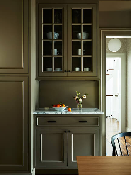 Easy Kitchen Makeover with dark cabinets, new lighting, and fresh furniture showing the power of paint in a modern update