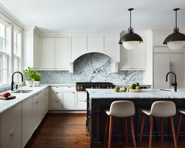 Boston interior designer creates a modern kitchen in a historic home with marble surfaces, sleek colors, and Allied Maker pendants