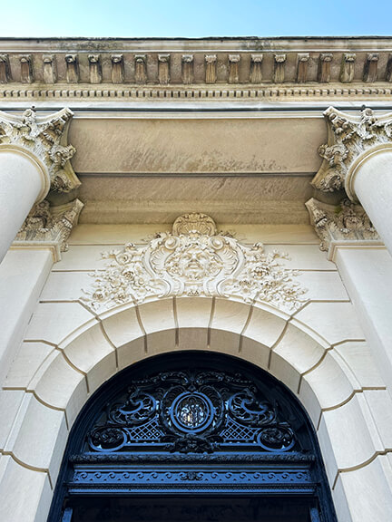 The Elms Newport Mansion French architecture with arched entry, decorative lintels, Greek columns, and limestone façade, HBO filming location.