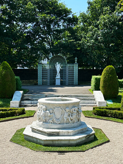 Filming location for HBO’s The Gilded Age at the Newport Rhode Island mansion The Elms, featuring the classic French garden with pavilions.