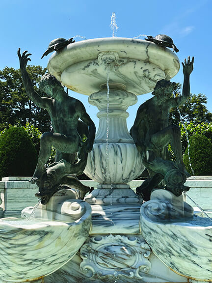 The Elms Newport Mansion marble fountain with bronze sculptures, part of the classic French garden and landscape design at the historic estate.