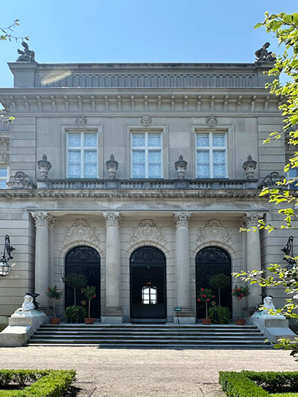 arched entry with columns and decorative cornices at
