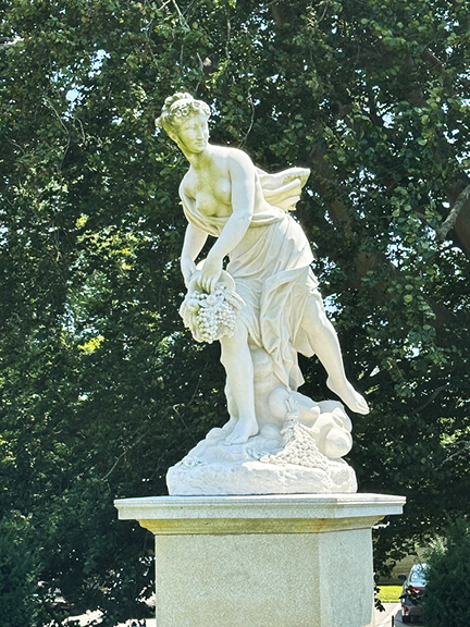 Garden sculpture of a Greek mythological marble figure at the historic Newport mansion The Elms estate in Rhode Island.