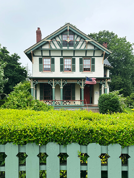 Greek Revival architecture in New England with octagonal tower and front porch, seen by historic home designer in Bristol, Rhode Island