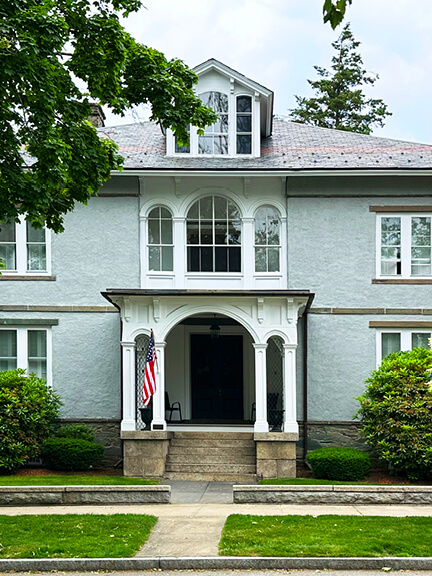 Historic Italianate home with white trim and light blue exterior in Bristol. new england historic home designer