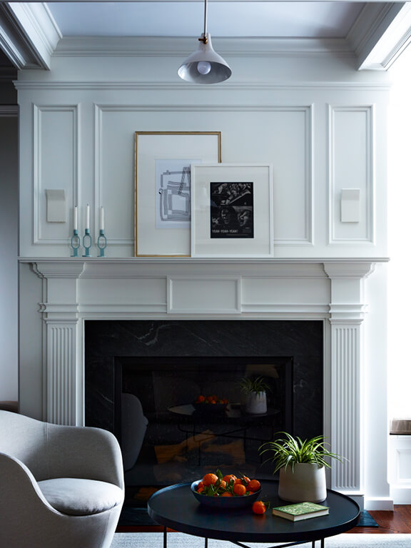 Historic Boston family room with original millwork, painted walls, and a mix of modern and traditional furnishings