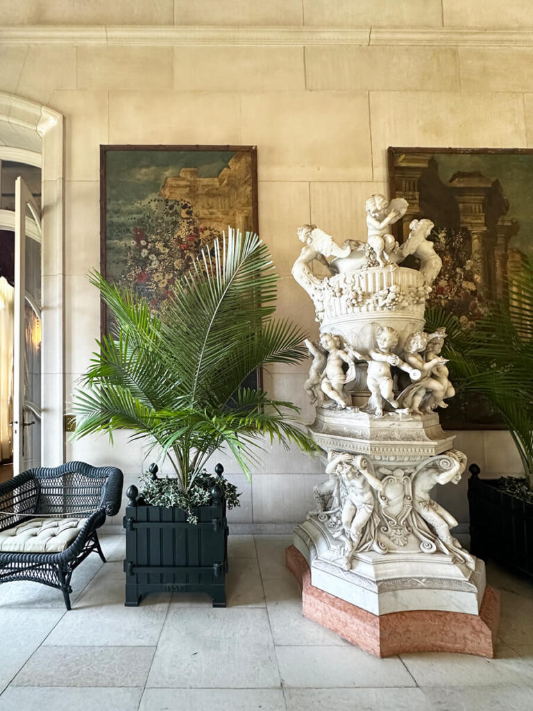 Antique furniture and art pieces displayed inside The Elms, a Newport mansion known for its detailed historic home design and craftsmanship.