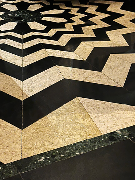 Patterned stone flooring at The Wolseley in London showcases classic restaurant design and traditional British architectural style.