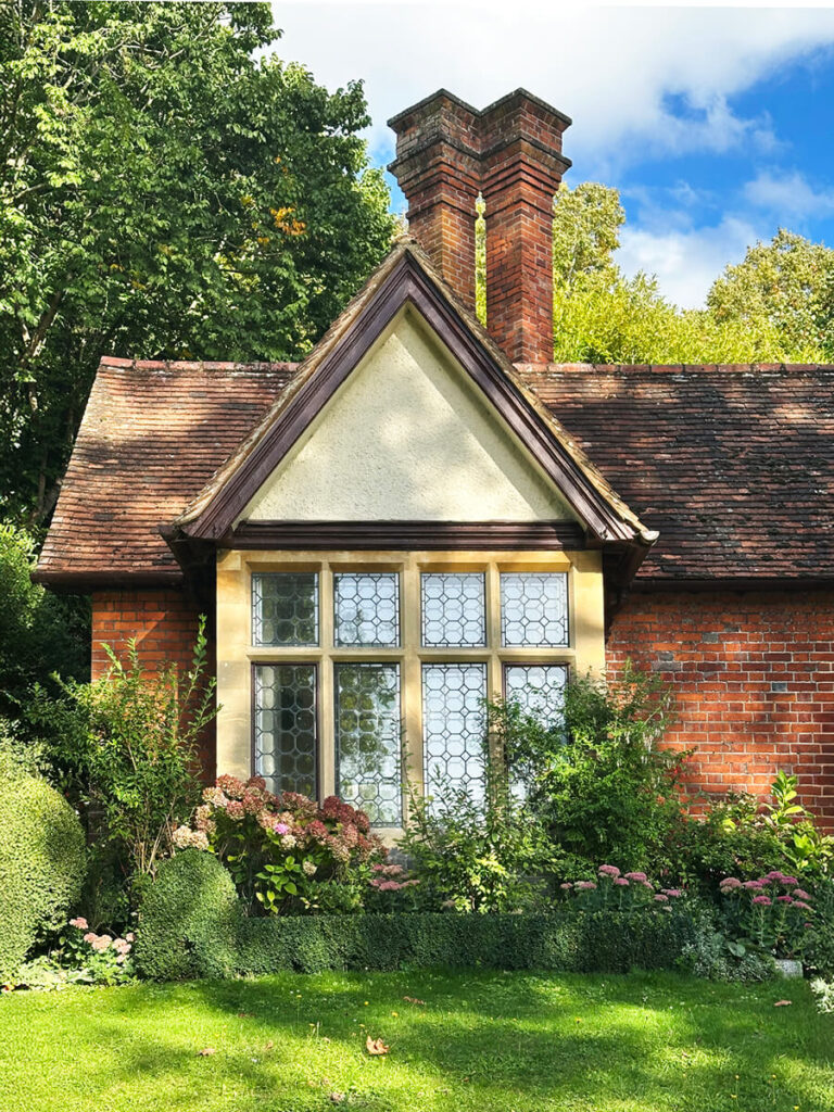 Brick and timber English cottage facade featuring exposed beams, leaded windows, and traditional craftsmanship in Buckinghamshire.