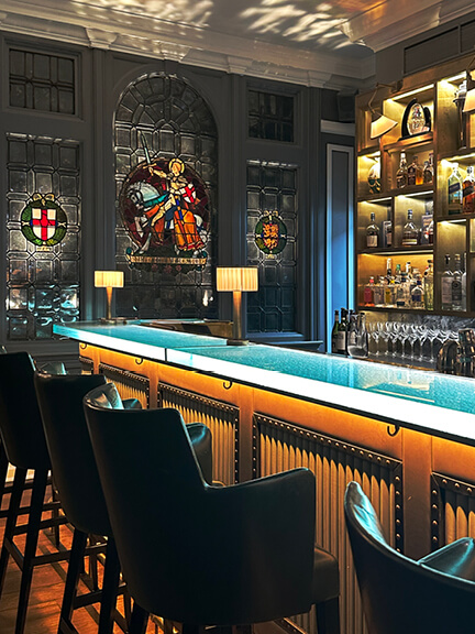 London restaurant design at Browns features colorful stained glass windows and traditional bar furniture in a historic London hotel restaurant.