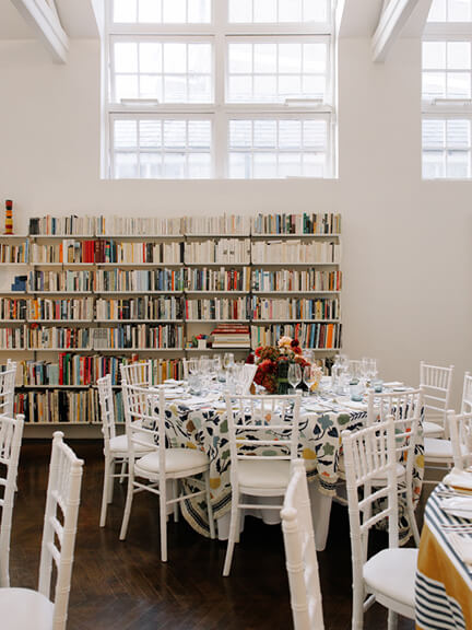 Christopher Farr Cloth table decor at the Chelsea anniversary party with layered textiles and floral arrangements.
