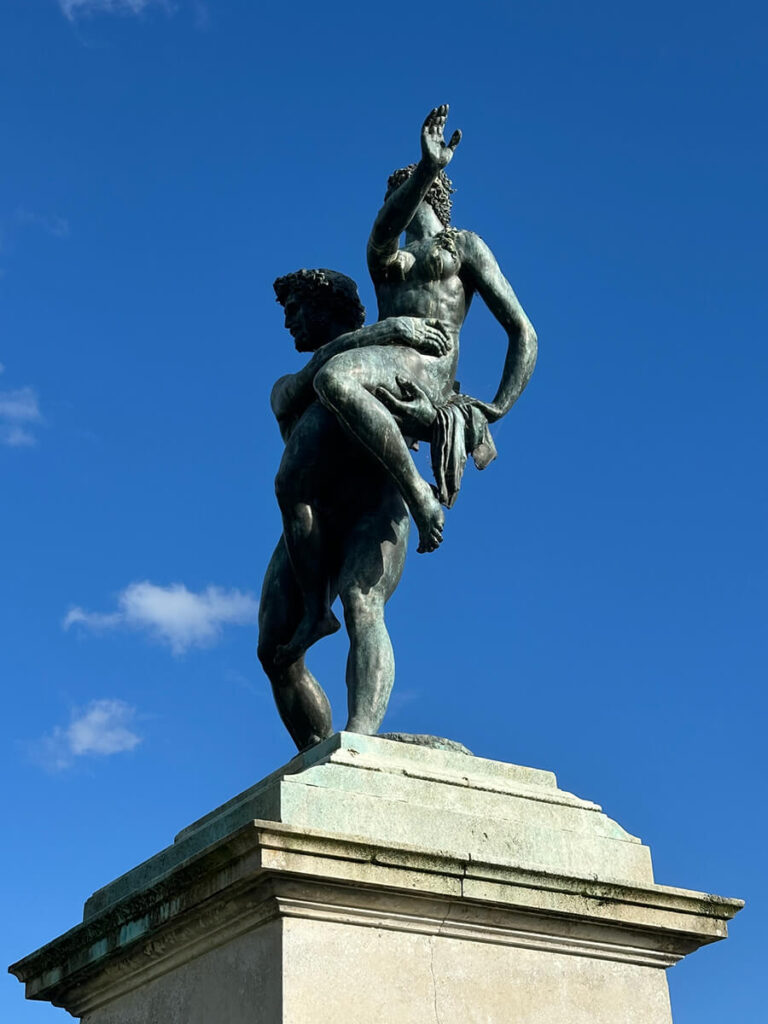 Historic English Estate Design shown through a bronze garden sculpture at Cliveden House, set among hedges and stone pathways.