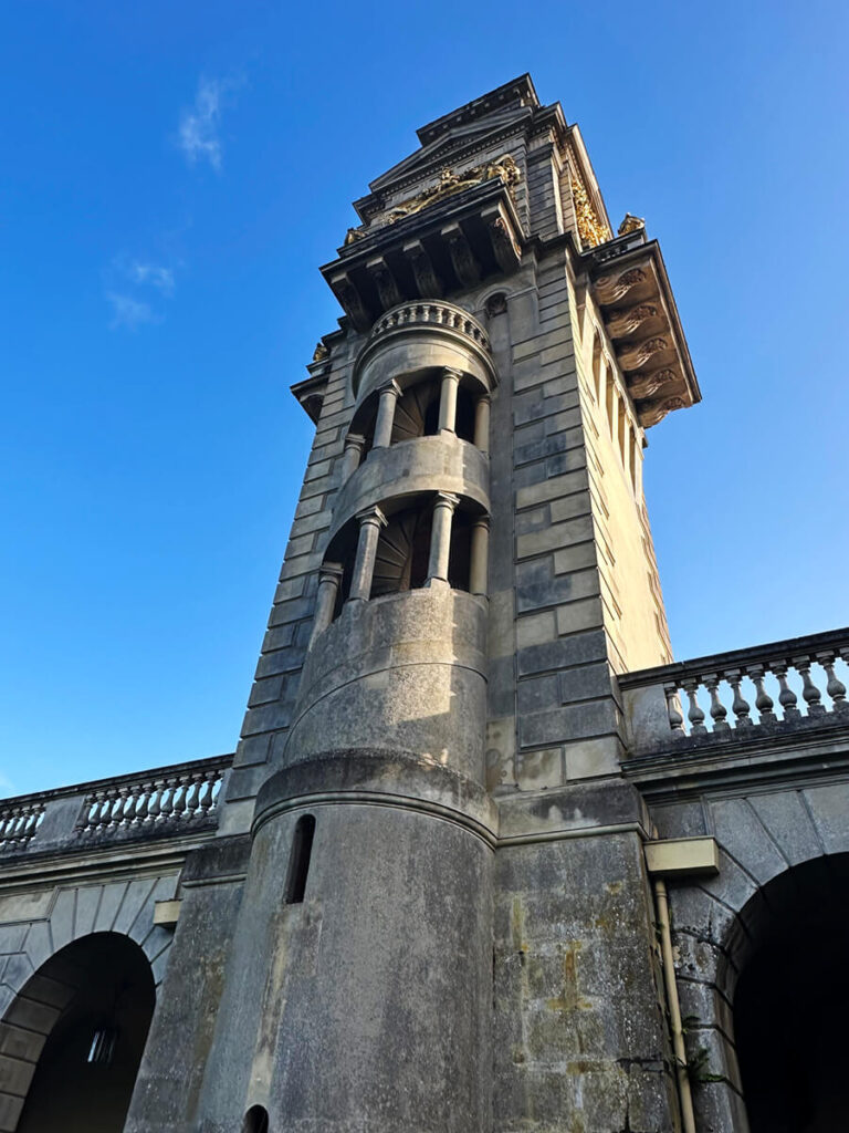 Historic English Estate Design represented by the clock tower at Cliveden House in Buckinghamshire, with carved stone and arched windows.
