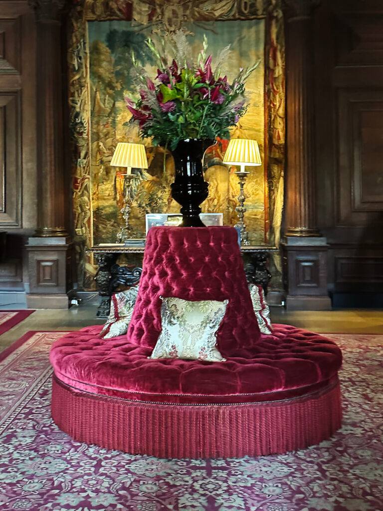 Cliveden House great hall featuring a 19th-century French borne settee, reflecting classic historic home design.