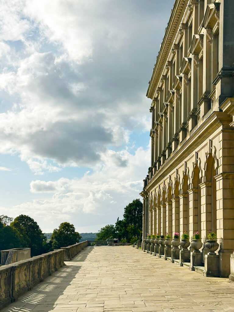 Rear patio arches at Cliveden House with stone balustrades, aged brickwork, and terrace views across the historic English estate.