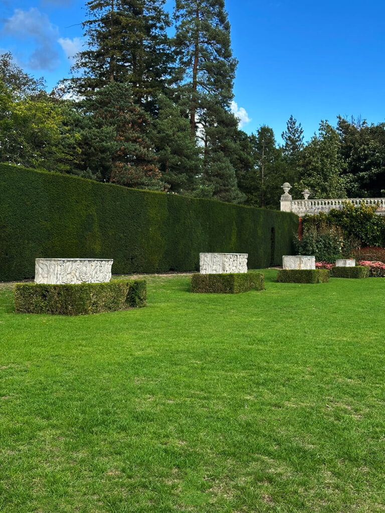 Historic English Estate Design highlighted by a Roman sarcophagus centerpiece in the front garden of Cliveden House in Buckinghamshire.