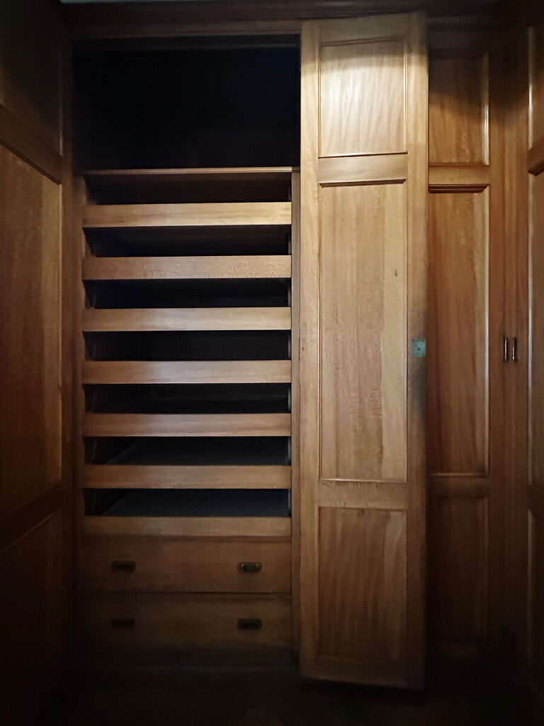 Custom closet design with natural wood millwork at The Elms in Newport, a refined example of Gilded Age Interior Design in New England.