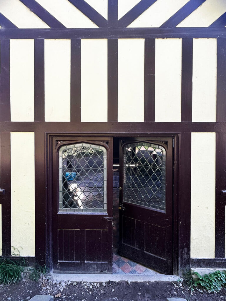 Historic English Estate Design reflected in the architecture of a timber and brick boathouse along the river at Cliveden House.