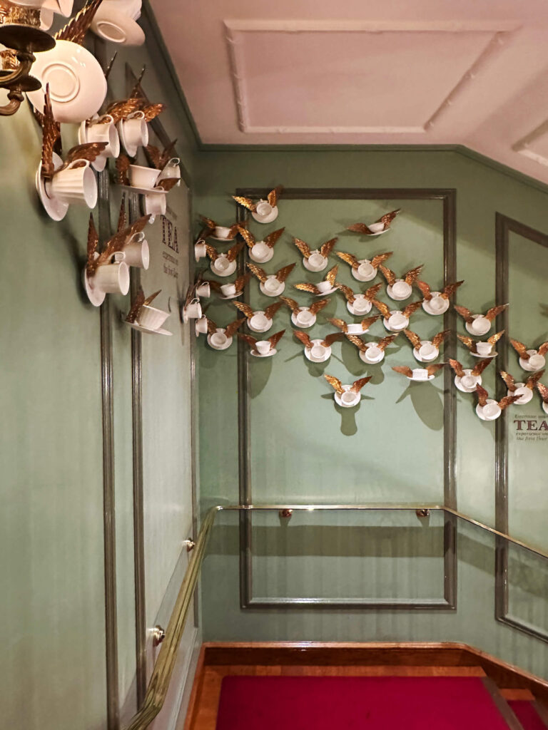 Fortnum & Mason Piccadilly interior featuring green walls, red carpet, and traditional British color palette.