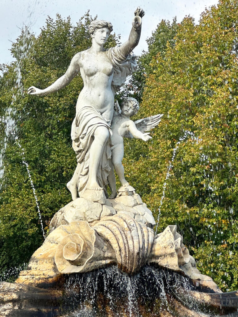 Fountain of Love at Cliveden House, a marble centerpiece surrounded by stone figures, water features, and landscaped gardens.