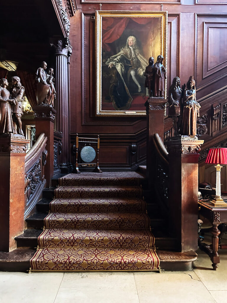 Grand staircase at Cliveden House with carved oak detail, showcasing timeless historic home design.