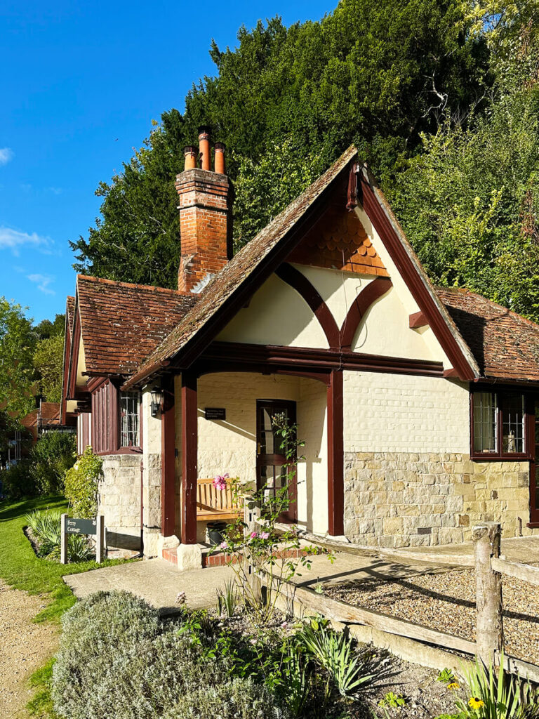 Half-timber cottage on an English estate in Buckinghamshire, featuring brick infill, pitched rooflines, and traditional leaded glass windows.