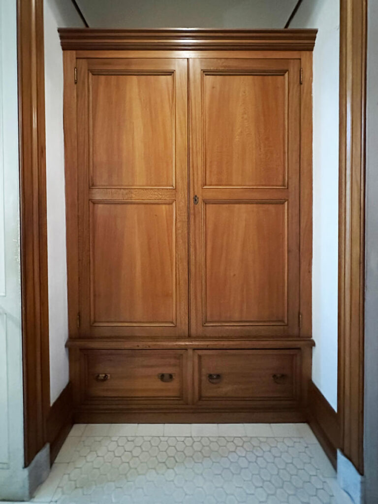 Handcrafted closet with wood detailing at The Elms in Newport, a fine example of Gilded Age Interior Design craftsmanship.