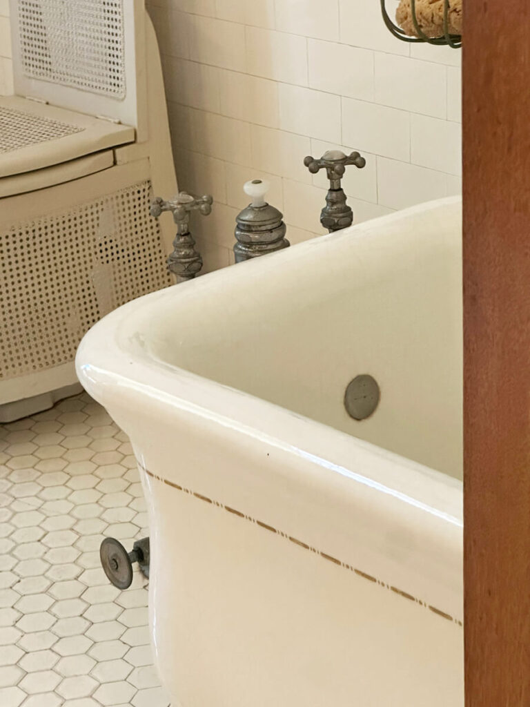 Historic bathroom design at The Elms in Newport Mansion with marble detailing and vintage fixtures.
