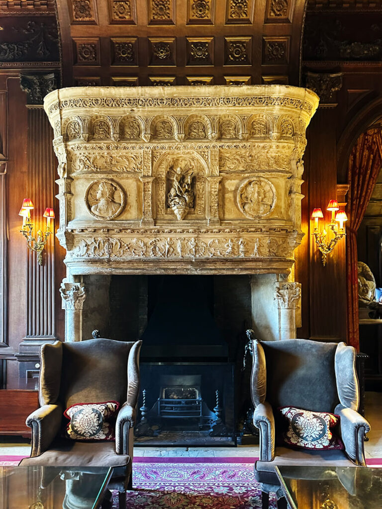 Historic French fireplace at Cliveden House blending European elegance with English manor interior design.
