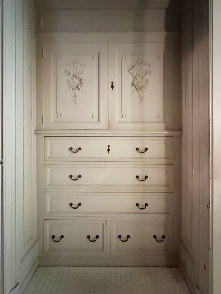 Closet with painted millwork and hand-painted details at The Elms in Newport, highlighting artistry and craftsmanship in historic home design.