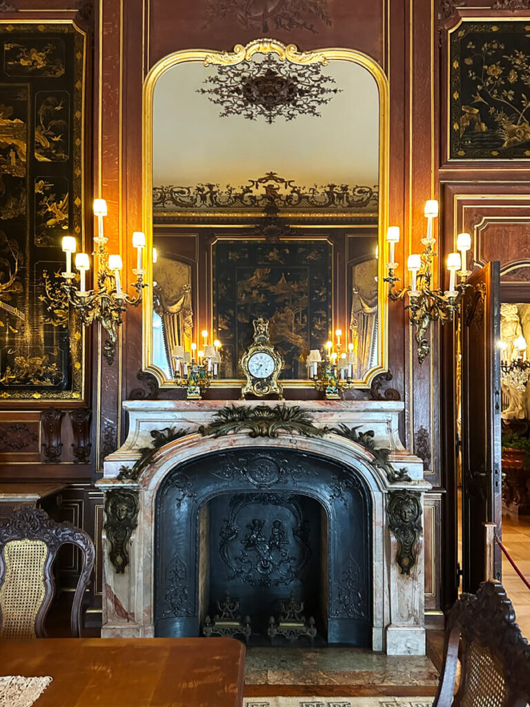 Historic marble fireplace at The Elms in Newport with ornate carvings and period detailing that reflect early 1900s craftsmanship.
