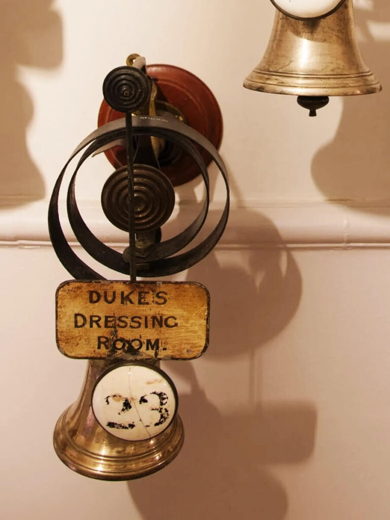 Original service bells at Cliveden House in England, preserved as part of classic British interior design heritage.