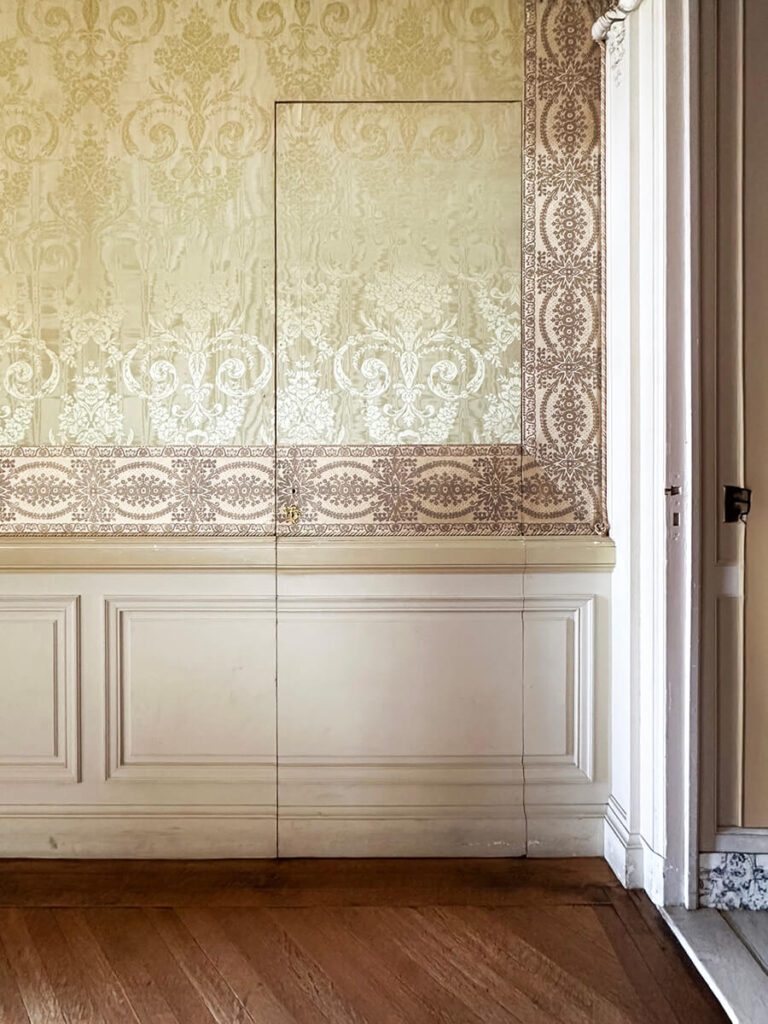 Pink and green damask wallpaper with white millwork at The Elms in Newport, a refined example of Gilded Age Interior Design.